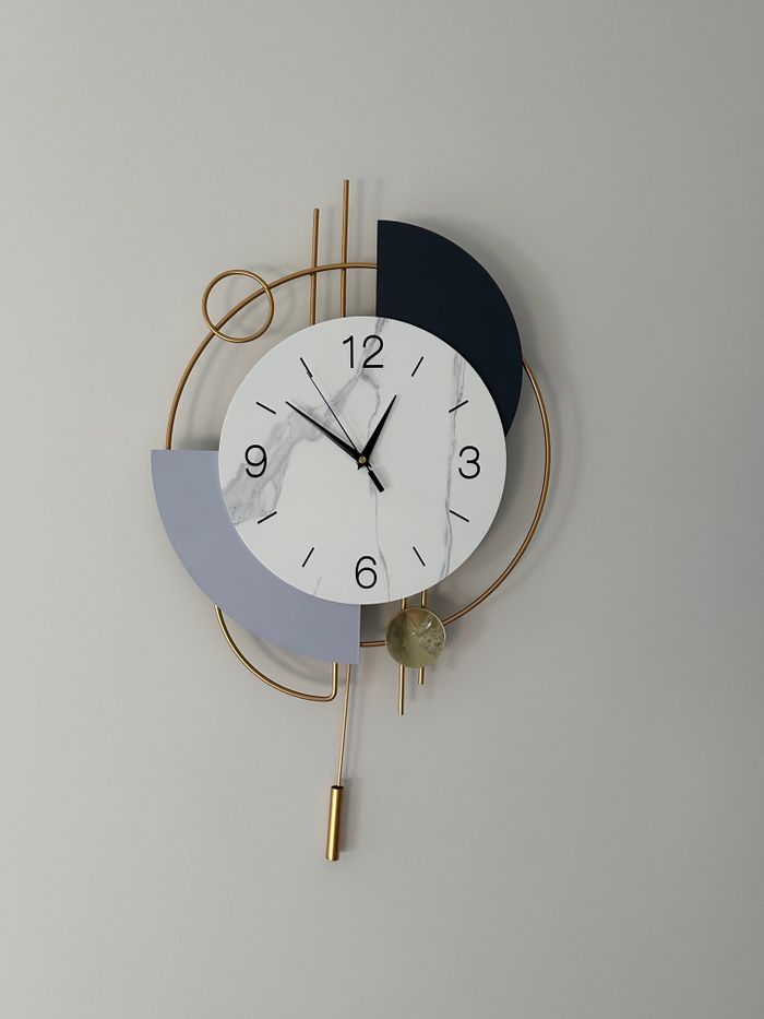 Elegant modern abstract wall clock with geometric shapes and gold accents.